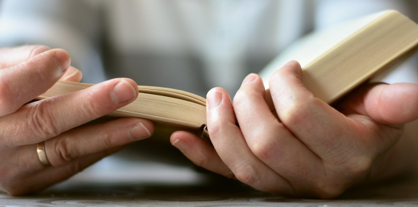 person reading an open book